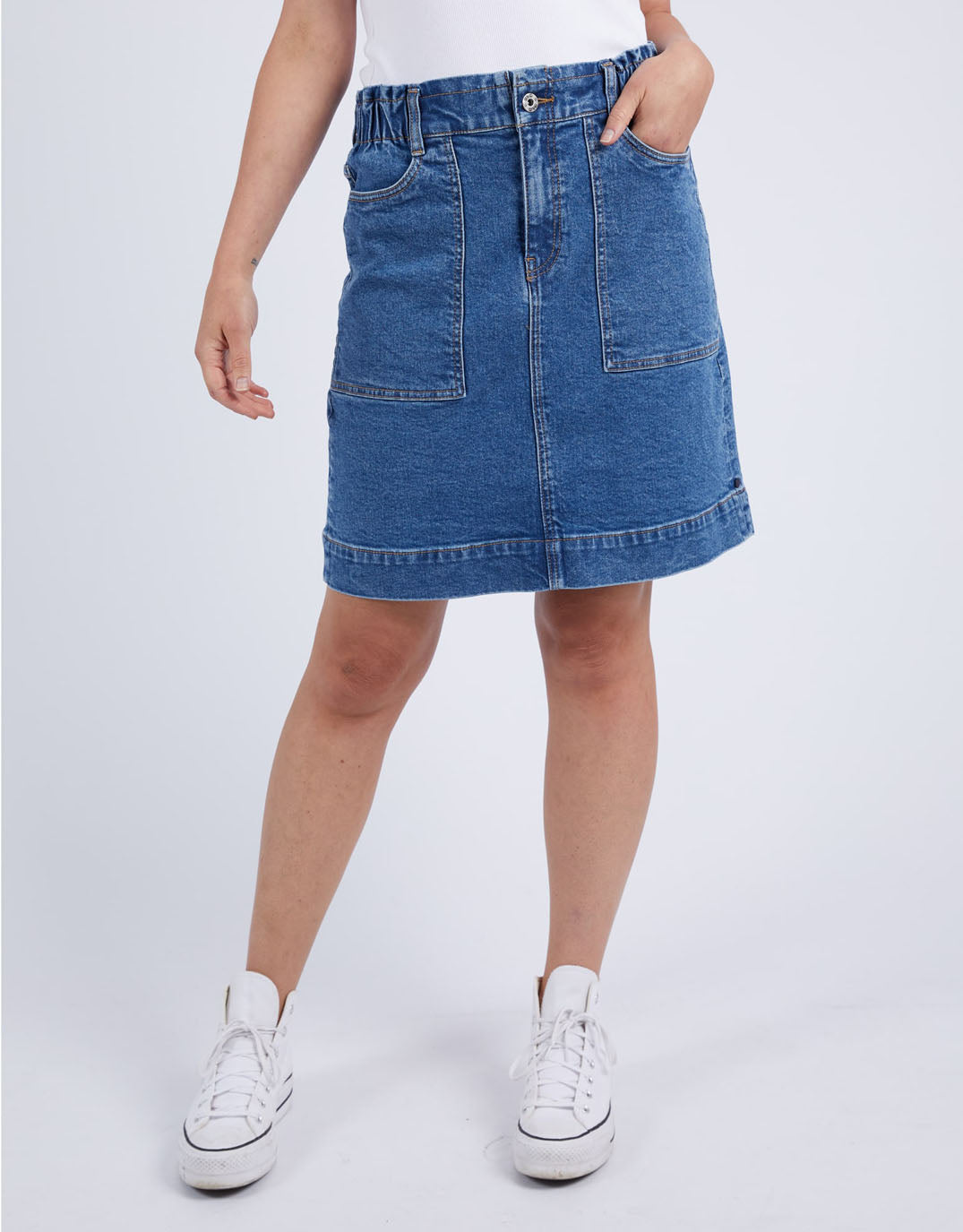 Image of a model wearing Skirts. Productname: Atlas Denim Skirt - in Dark Blue Wash colour by brand - Elm