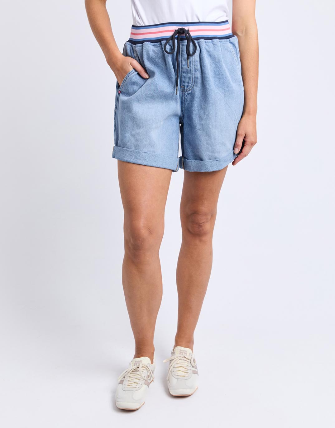 Image of a model wearing Shorts. Productname: Bodhi Denim Short - in Mid Blue Wash colour by brand - Elm