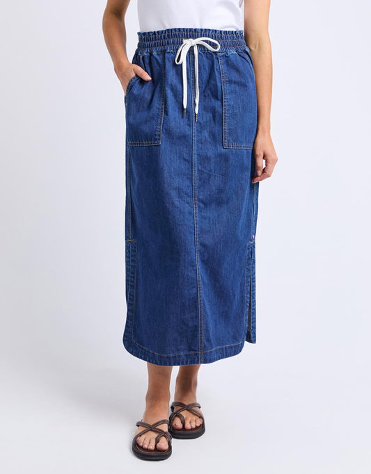Image of a model wearing Skirts. Productname: Clover Midi Denim Skirt - in Mid Blue Wash colour by brand - Elm