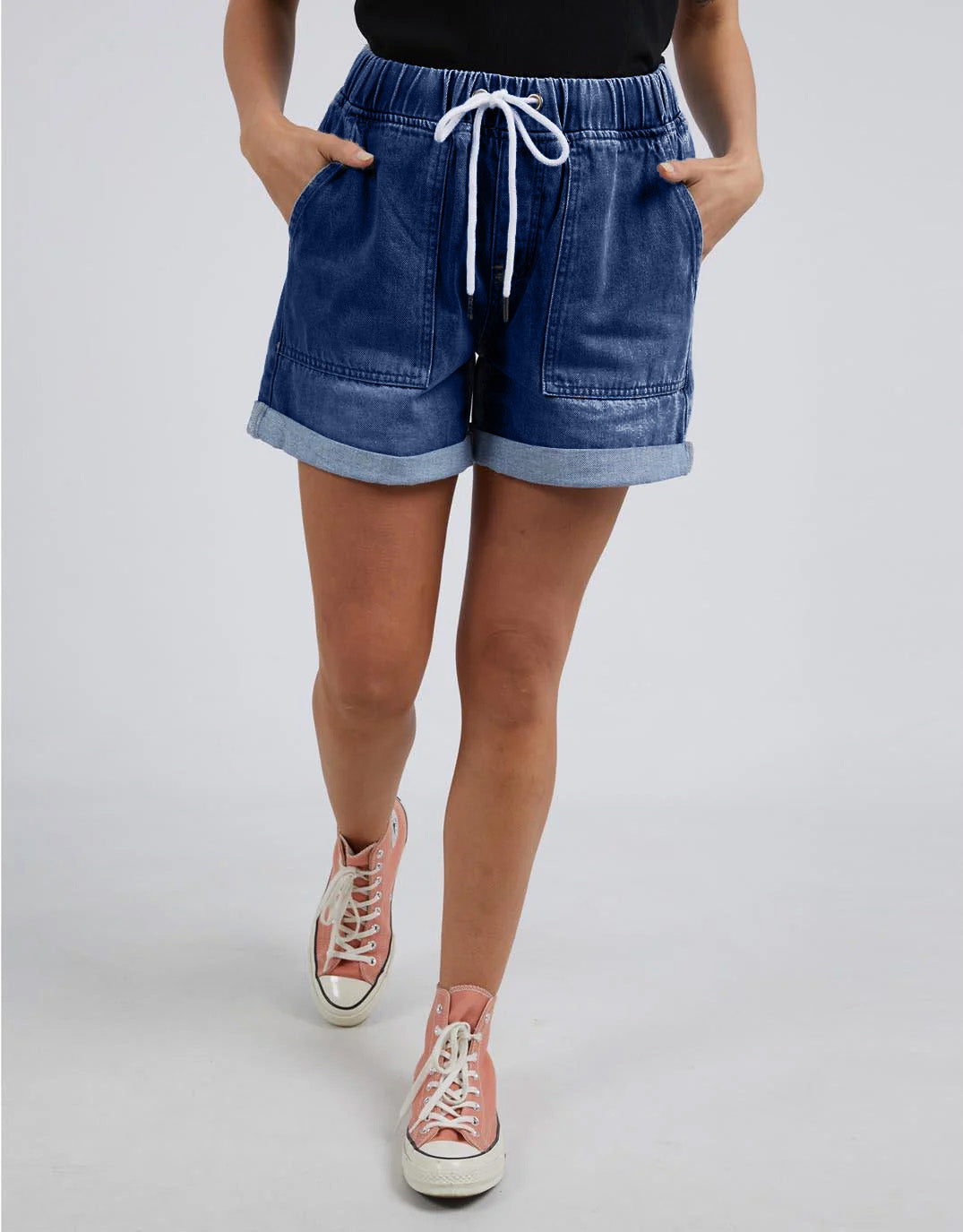 Image of a model wearing Shorts. Productname: Emma Relaxed Denim Short - in Dark Blue Wash colour by brand - Elm