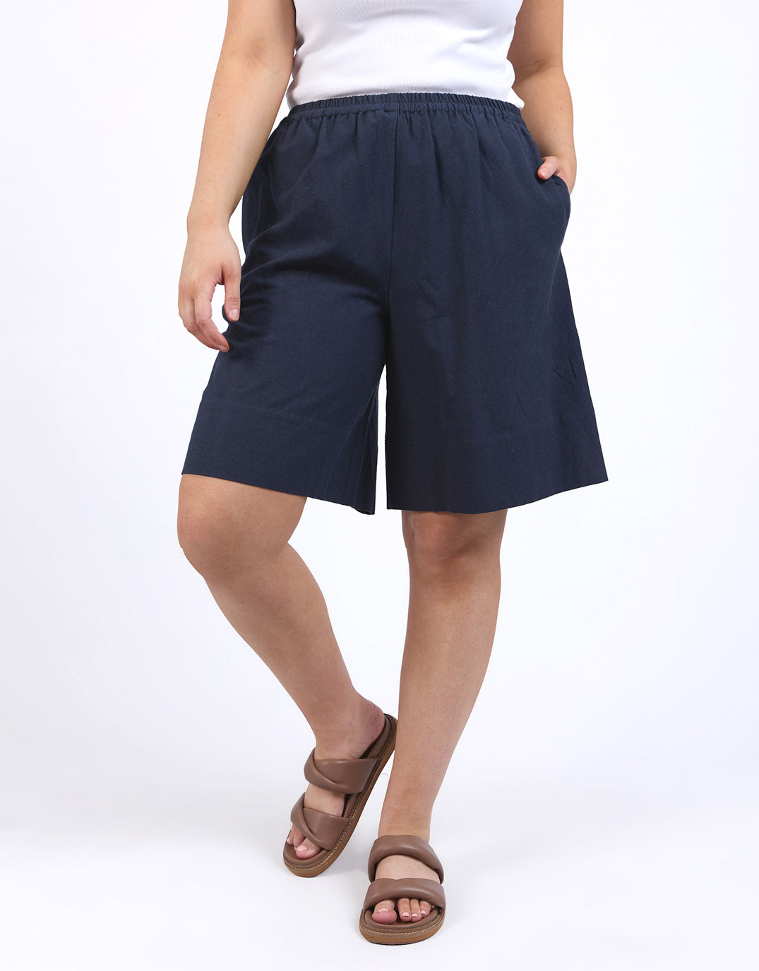 Image of a model wearing Shorts. Productname: Ginny Linen Shorts - in Navy colour by brand - Elm