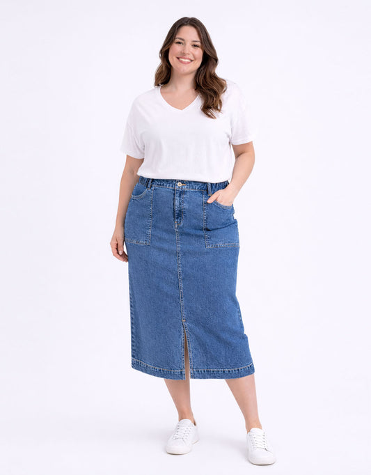 Image of a model wearing Pants. Productname: Long Atlas Skirt - in Dark Blue Wash colour by brand - Elm