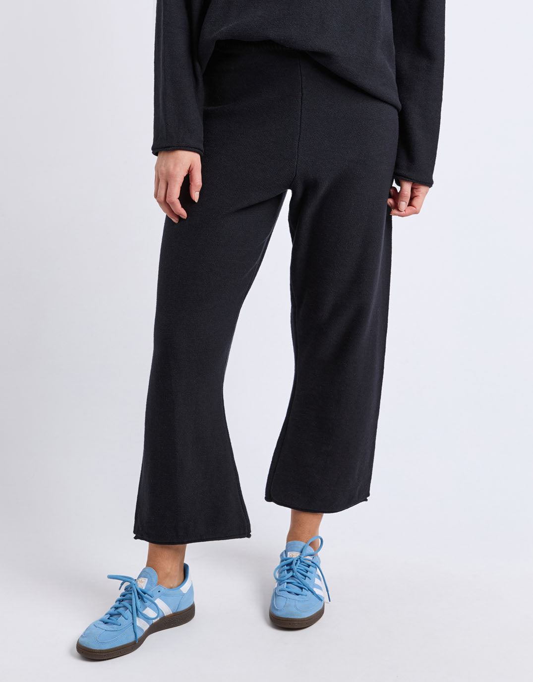 Image of a model wearing Pants. Product name - Marley Knit Pant Black in Black colour by brand - Elm