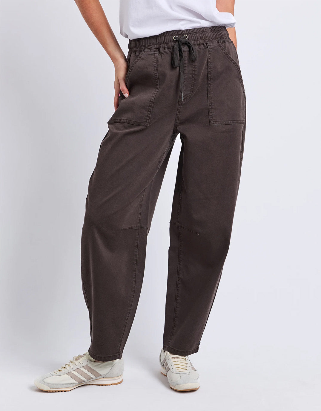 Image of a model wearing Pants. Product name - Quinn Barrel Jogger Chocolate in Chocolate colour by brand - Elm