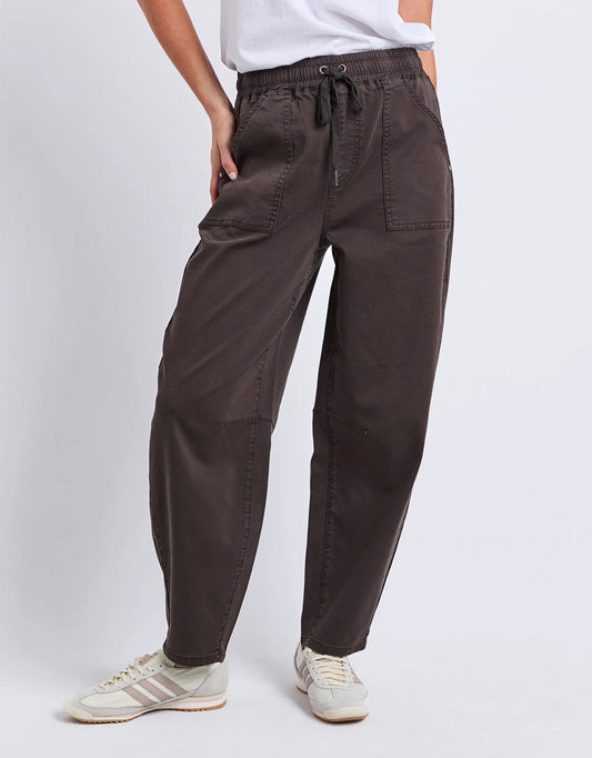 Image of a model wearing Pants. Product name - Quinn Barrel Jogger Chocolate in Chocolate colour by brand - Elm