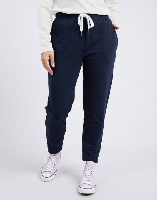 Image of a model wearing Pants. Product name - The Lobby Pant Navy in Navy colour by brand - Elm