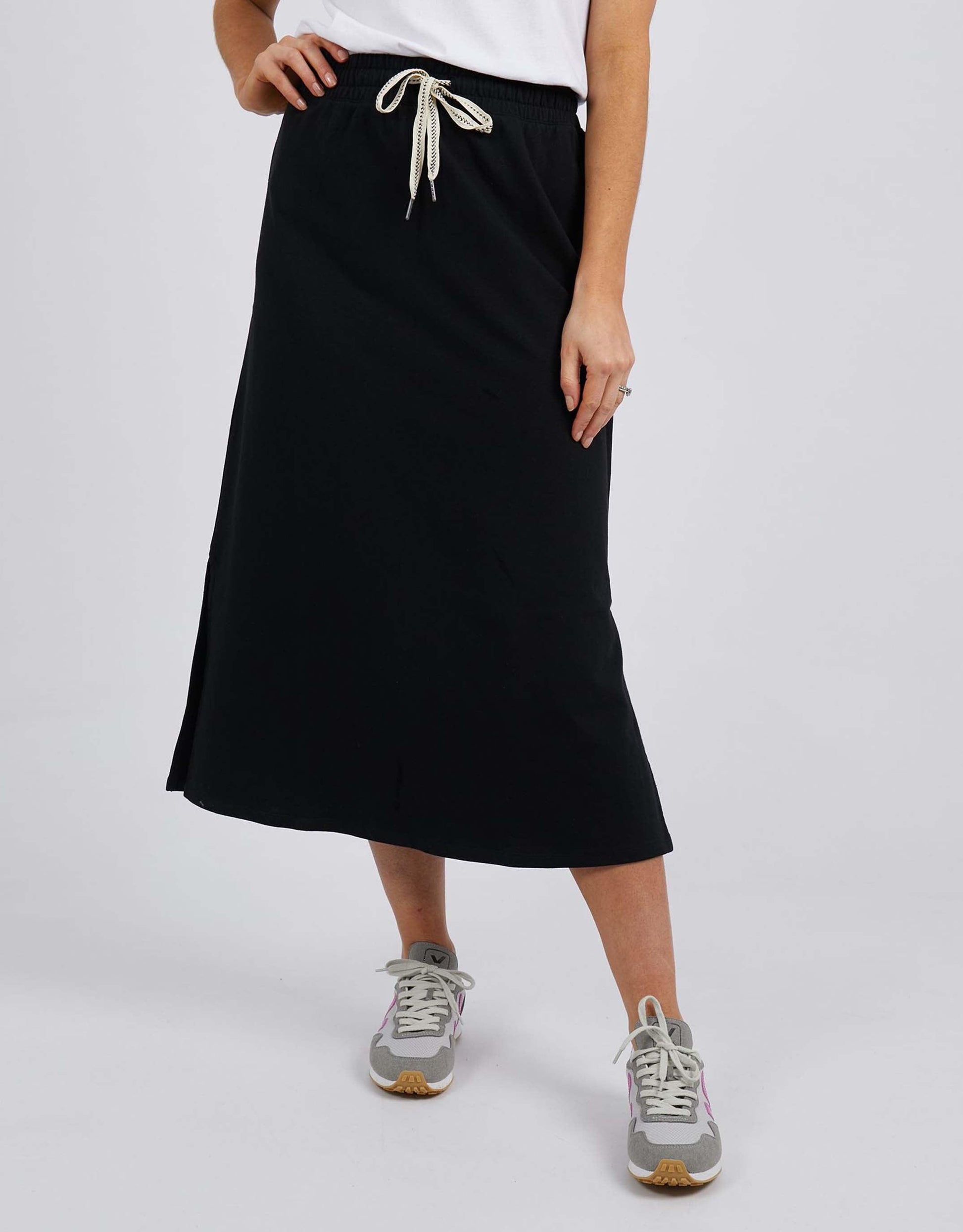 Image of a model wearing Skirts. Productname: Travel Skirt - in Black colour by brand - Elm