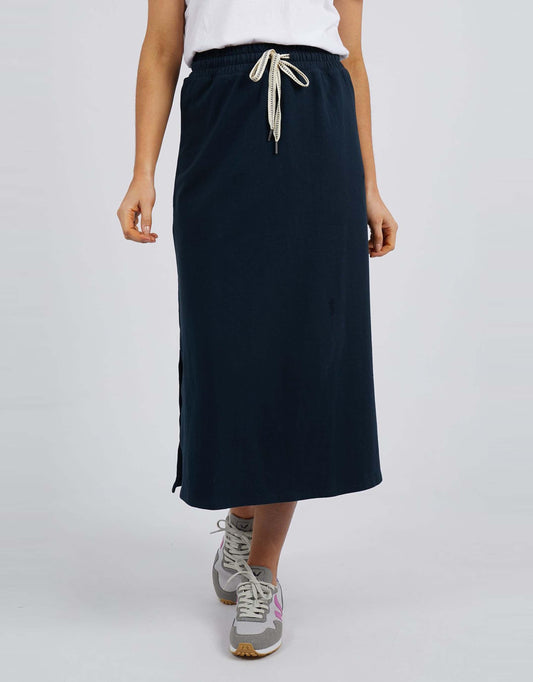 Image of a model wearing Skirts. Product name - Travel Skirt Navy in Navy colour by brand - Elm