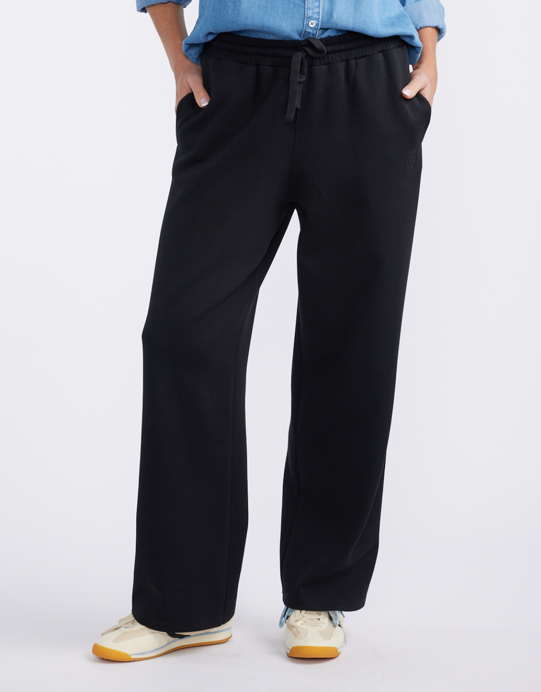 Image of a model wearing Pants. Product name - Escape Super Soft Lounge Pant Black in Black colour by brand - White & Co.