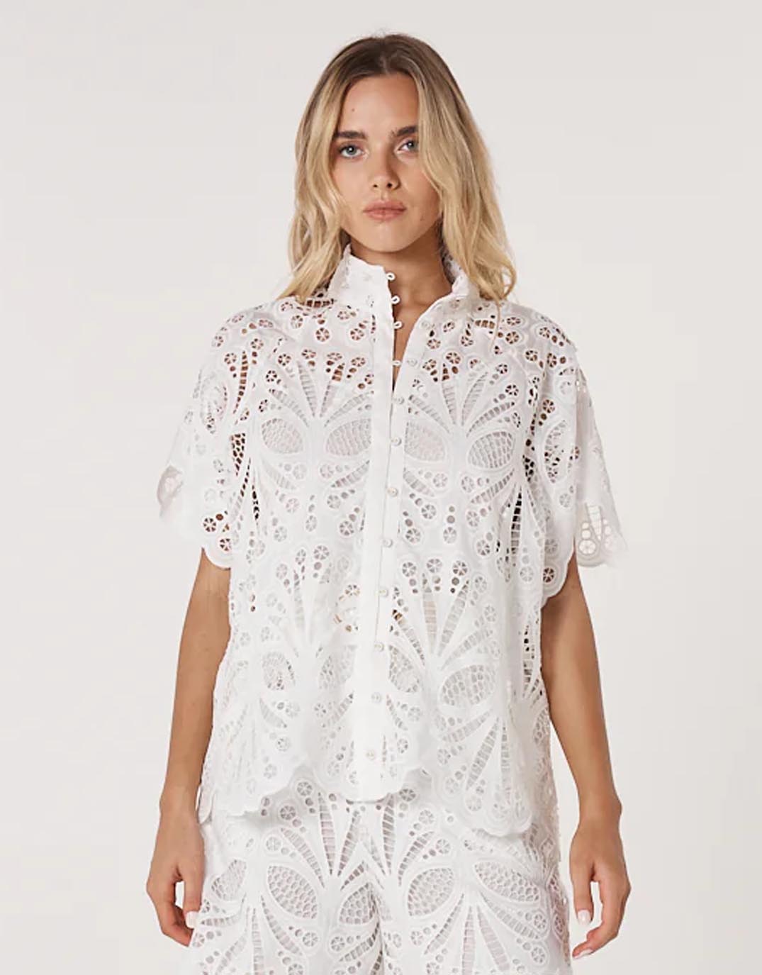 Image of a model wearing Tops. Productname: Elara Broderie Blouse - in Ivory colour by brand - Fate and Becker