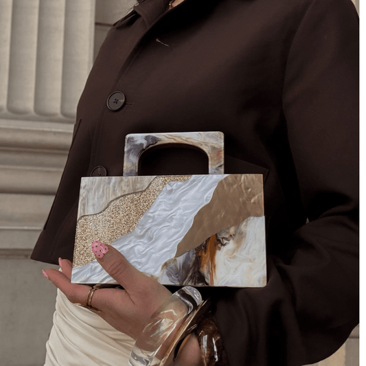 Image of a model wearing Tops. Productname: FLEUR Acrylic Top Handle in colour by brand - Olga Berg