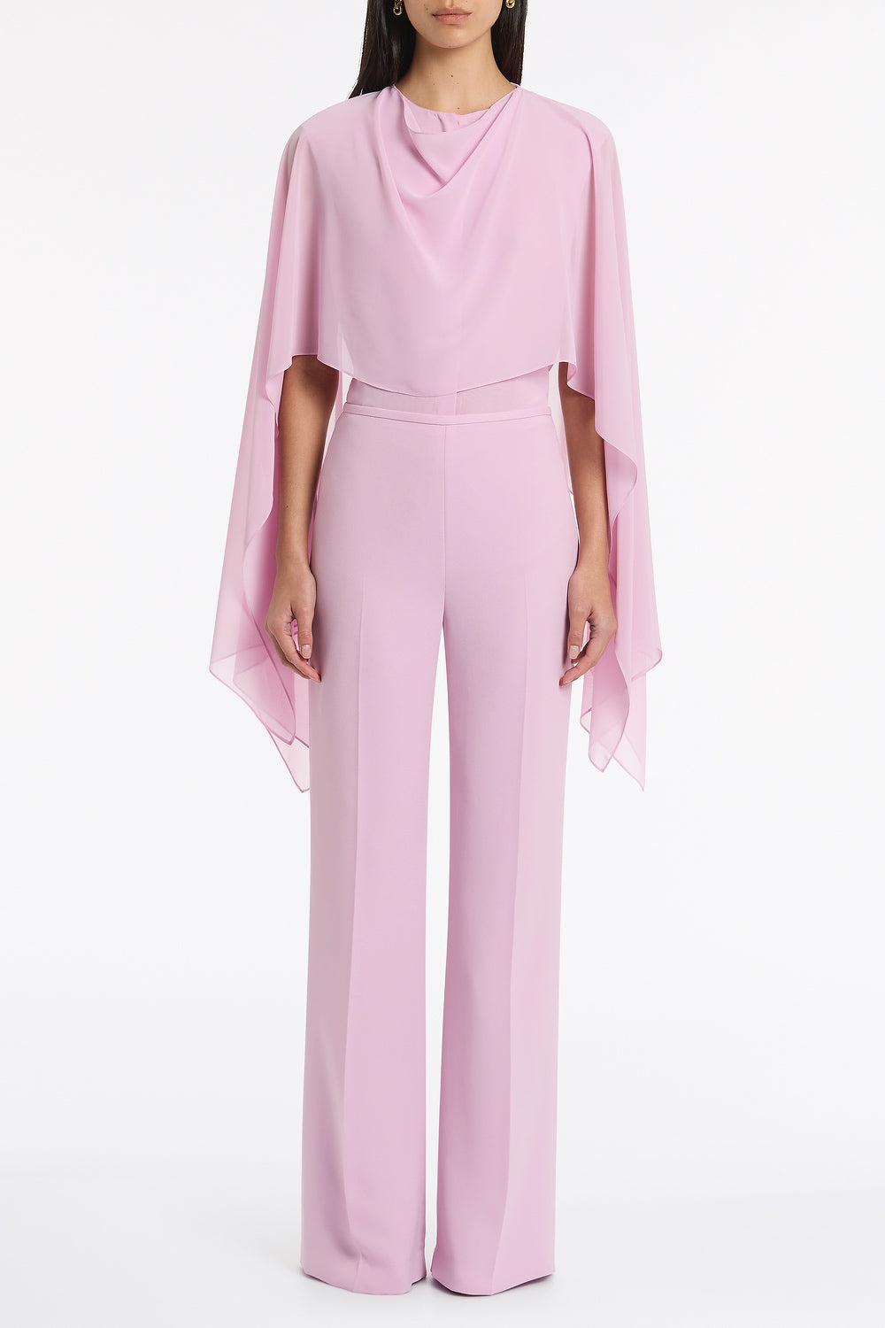 Image of a model wearing Tops. Product name - Floss Georgette Cape Overlay Blouse in Pink colour by brand - Carla Zampatti