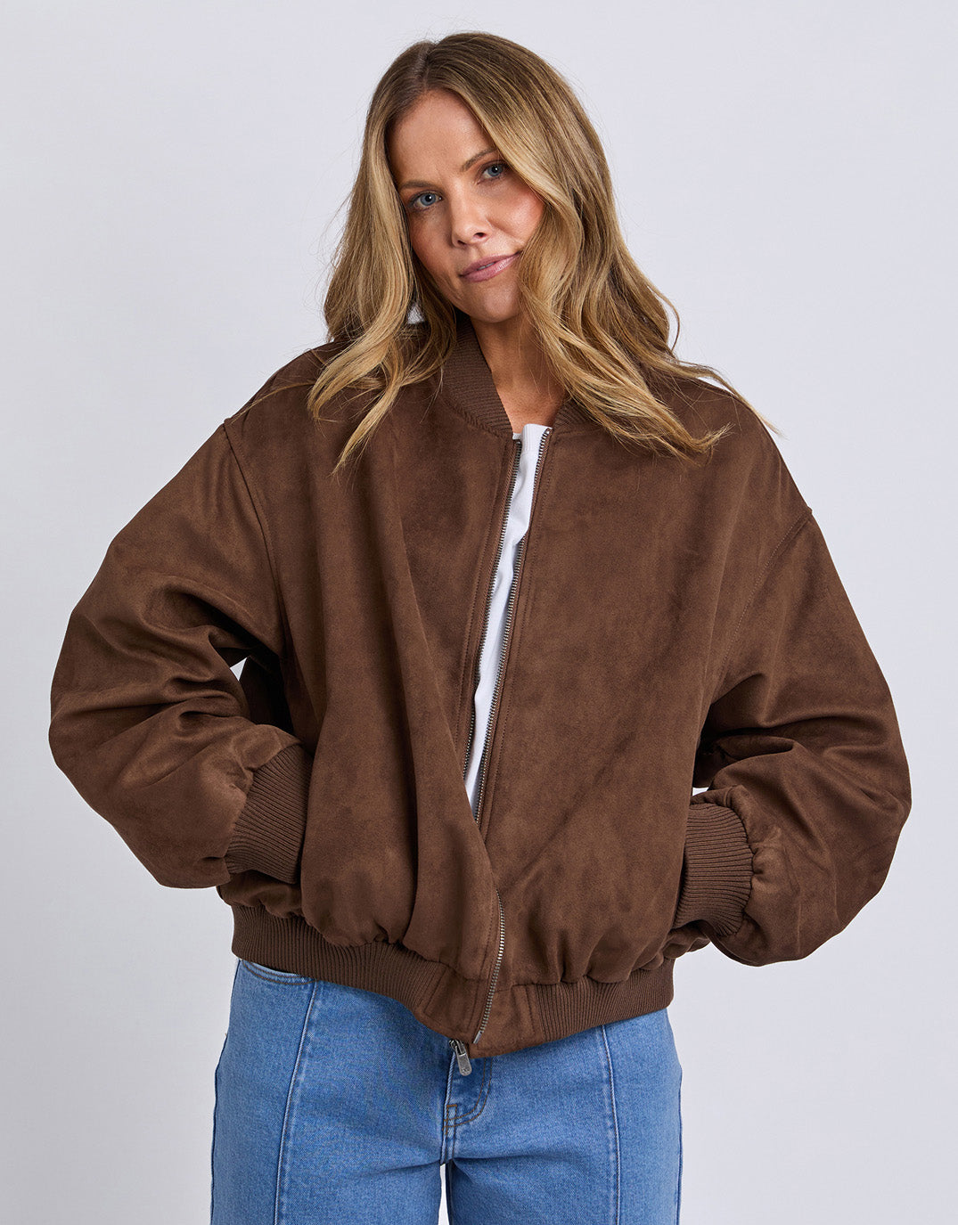 Image of a model wearing Outerwear. Product name - Evie Suede Bomber Chocolate in Chocolate colour by brand - Foxwood