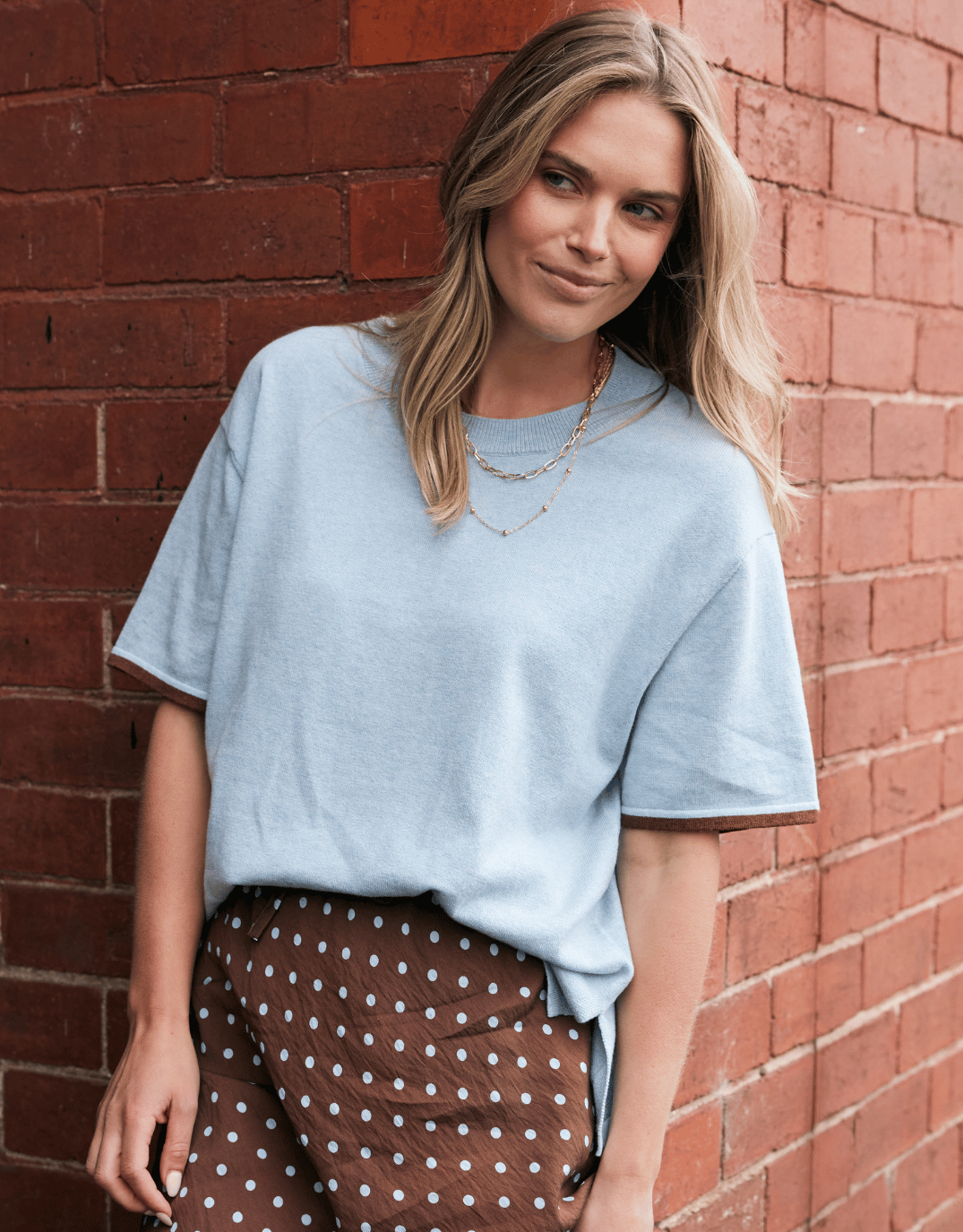 Image of a model wearing Outerwear. Product name - Frenchie Cotton Cashmere Tee Ice Blue in Ice Blue colour by brand - White & Co.