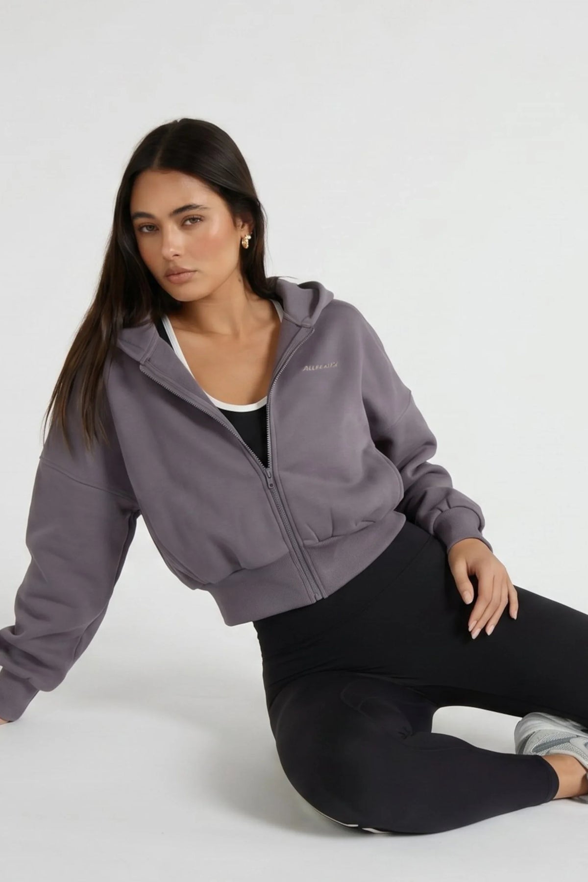 Image of a model wearing Outerwear. Product name - Cropped Zip Hoodie in Gray colour by brand - All Fenix