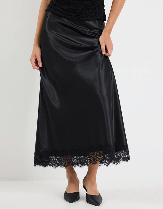 Image of a model wearing Skirts. Product name - Margarita Satin Lace Trim Bias Maxi Skirt Black in Black colour by brand - Georgia Zoe