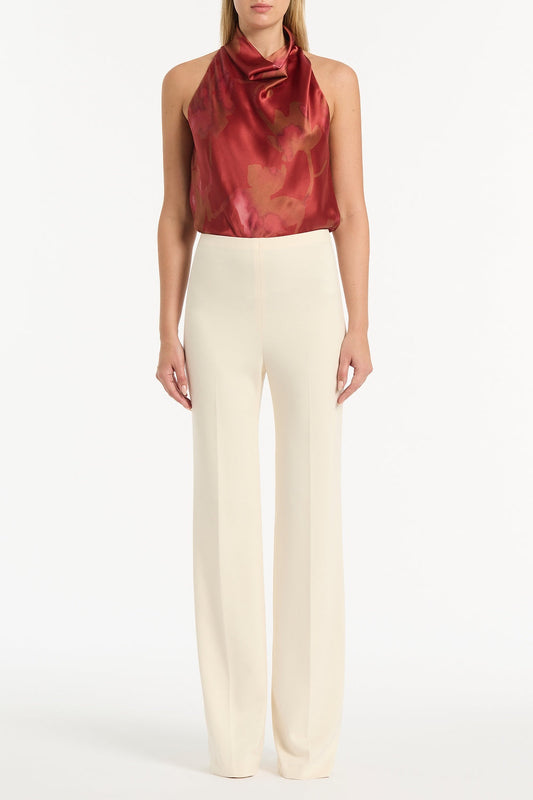 Image of a model wearing Tops. Product name - Grandiflora Silk Halter Top in Red colour by brand - Carla Zampatti