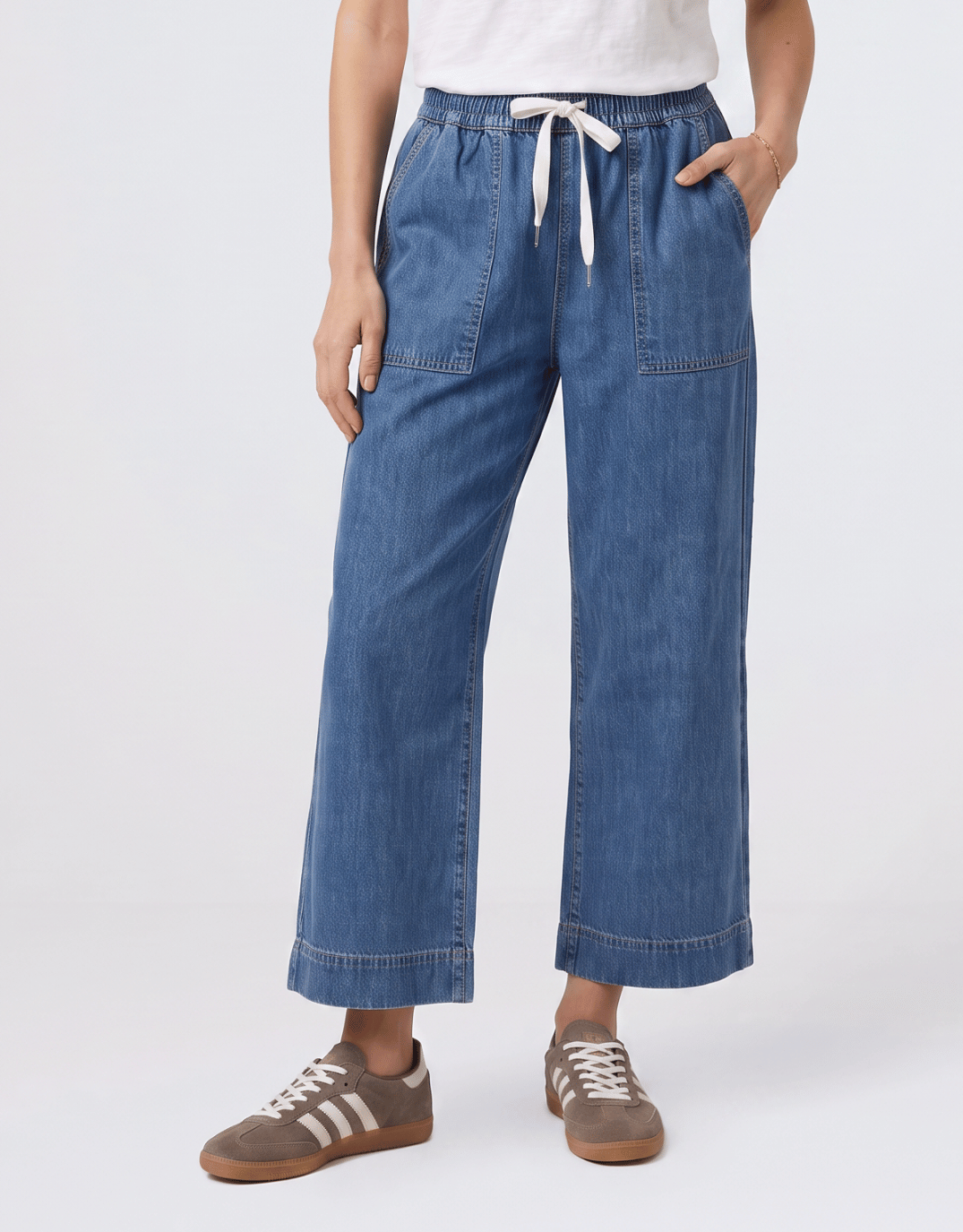 Image of a model wearing Pants. Product name - Greta Slim Leg Pant Blue in Blue colour by brand - Elm