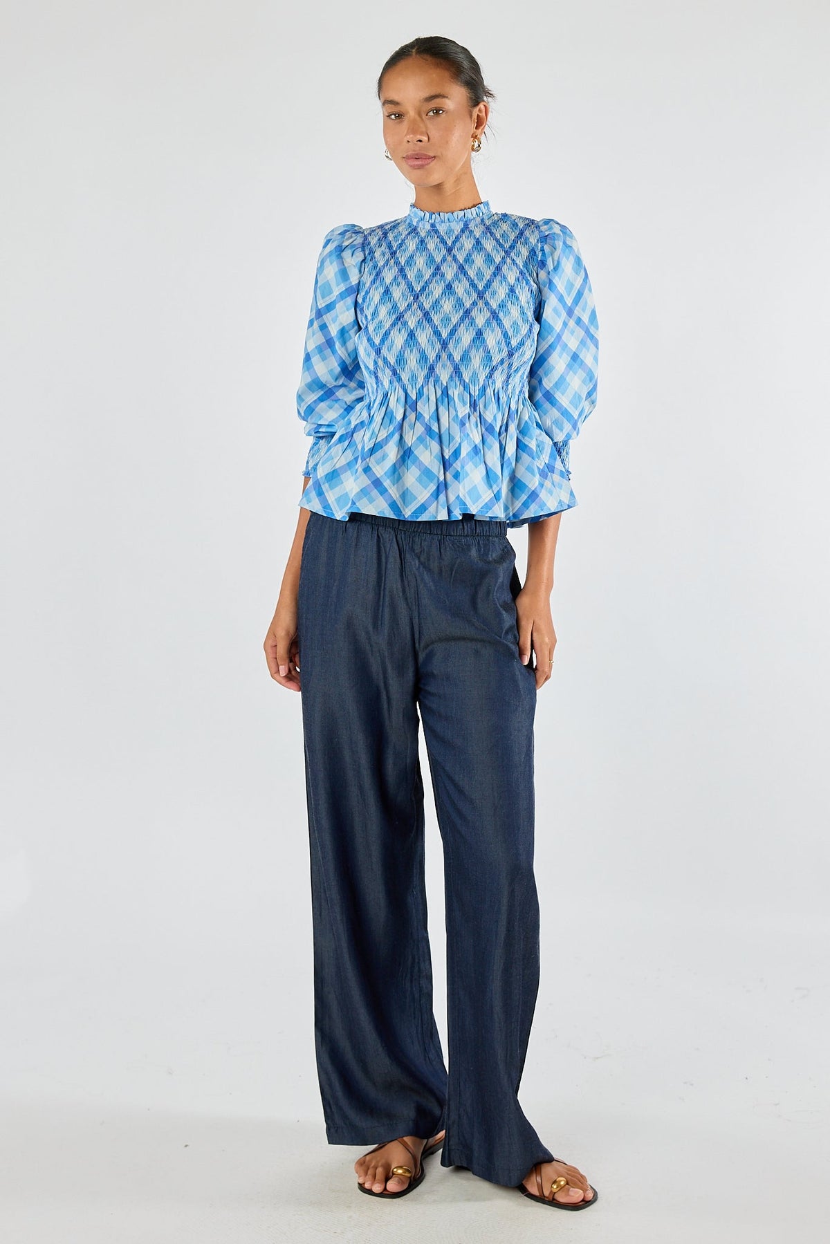 Image of a model wearing Tops. Product name - Itami Check Ruched Top Blue in Blue colour by brand - Itami Division