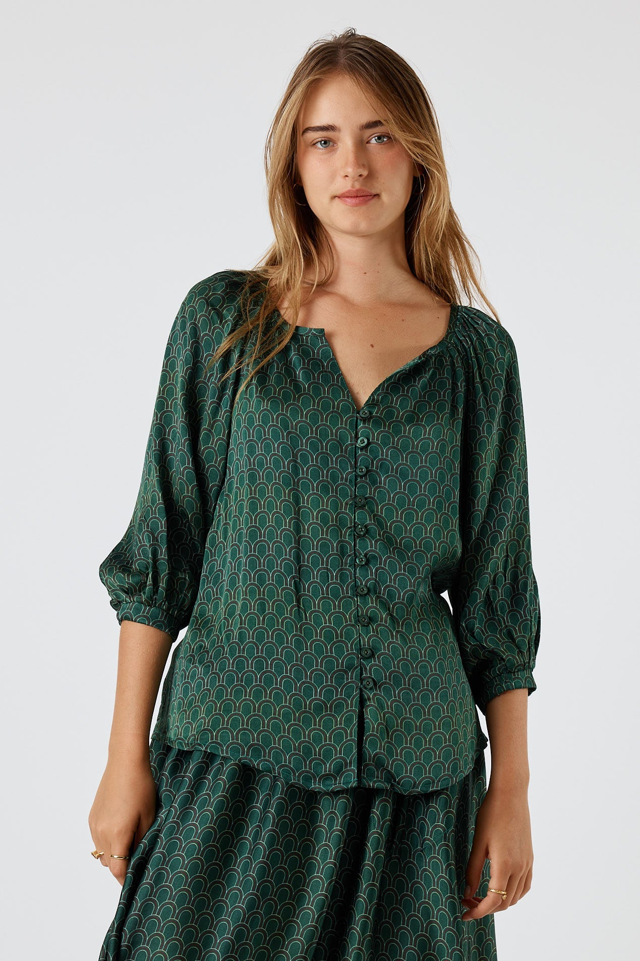 Image of a model wearing Tops. Product name - Itami Emilie Top Green in Green colour by brand - Itami Division