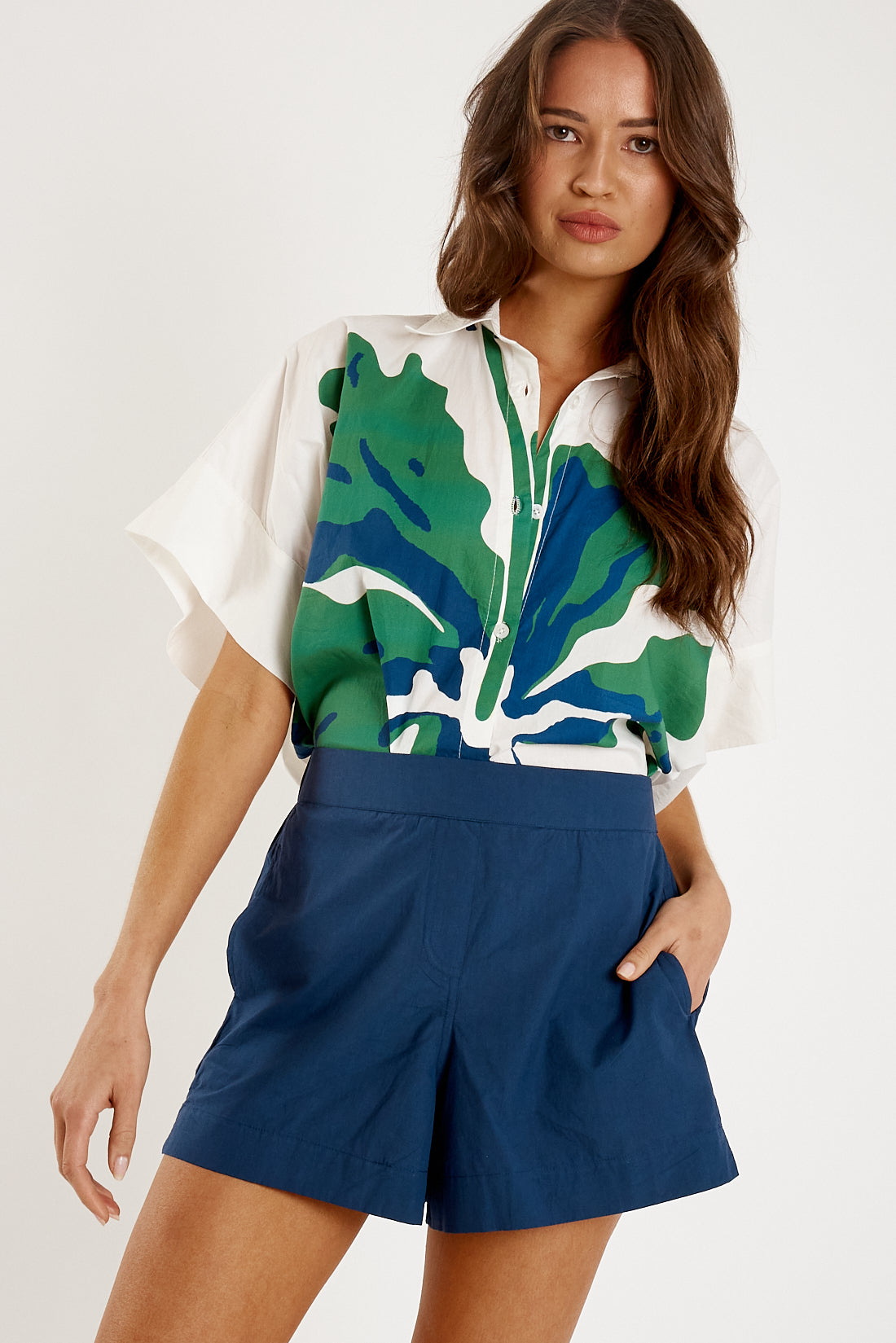 Image of a model wearing Shorts. Product name - Itami Staple Short Navy in Navy colour by brand - Itami Division