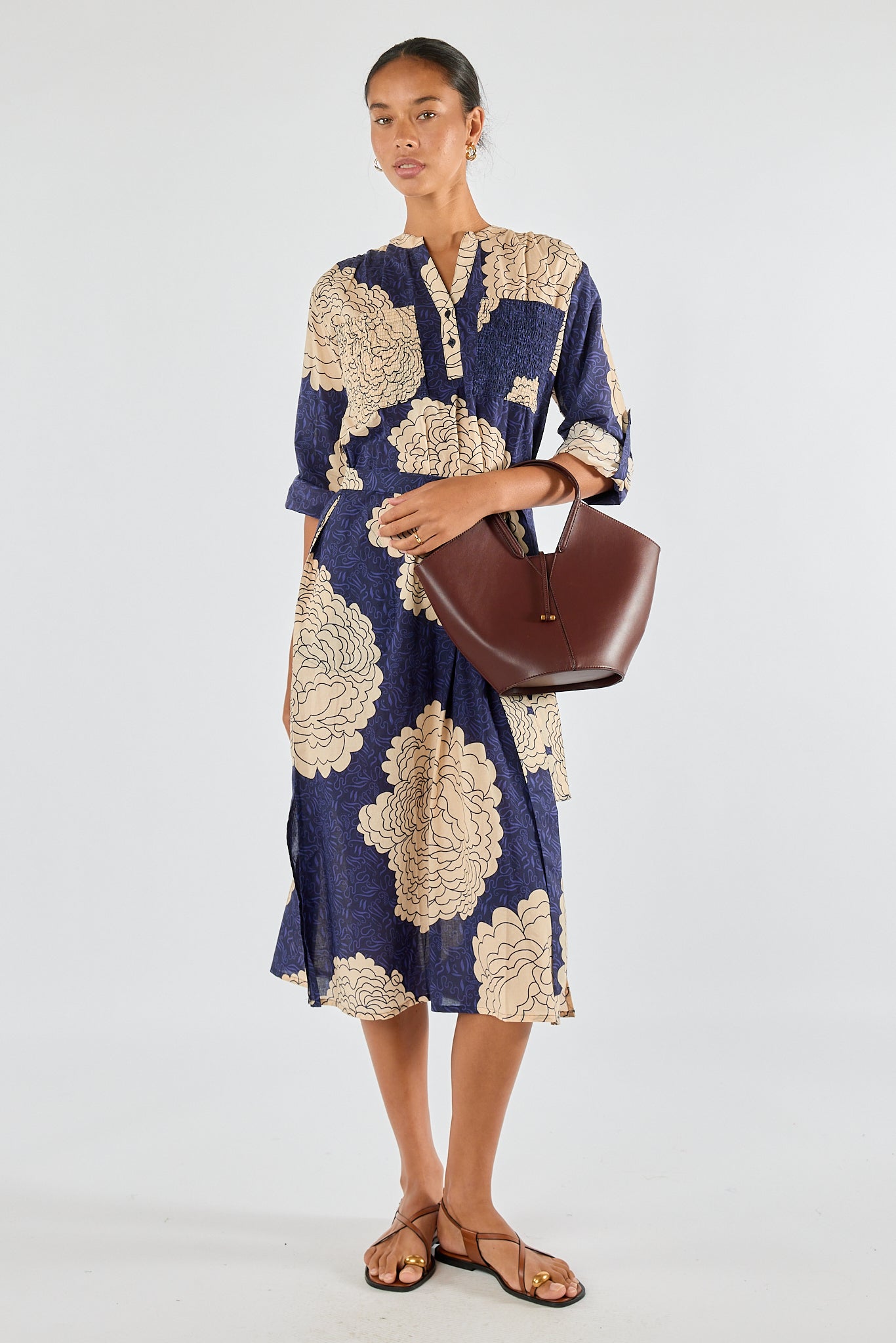 Image of a model wearing Tops. Product name - Itami Orient Long Sleeve Dress Navy in Navy colour by brand - Itami Division