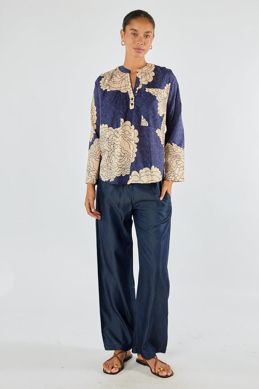 Image of a model wearing Tops. Product name - Itami Orient Long Sleeve Top Navy in Navy colour by brand - Itami Division