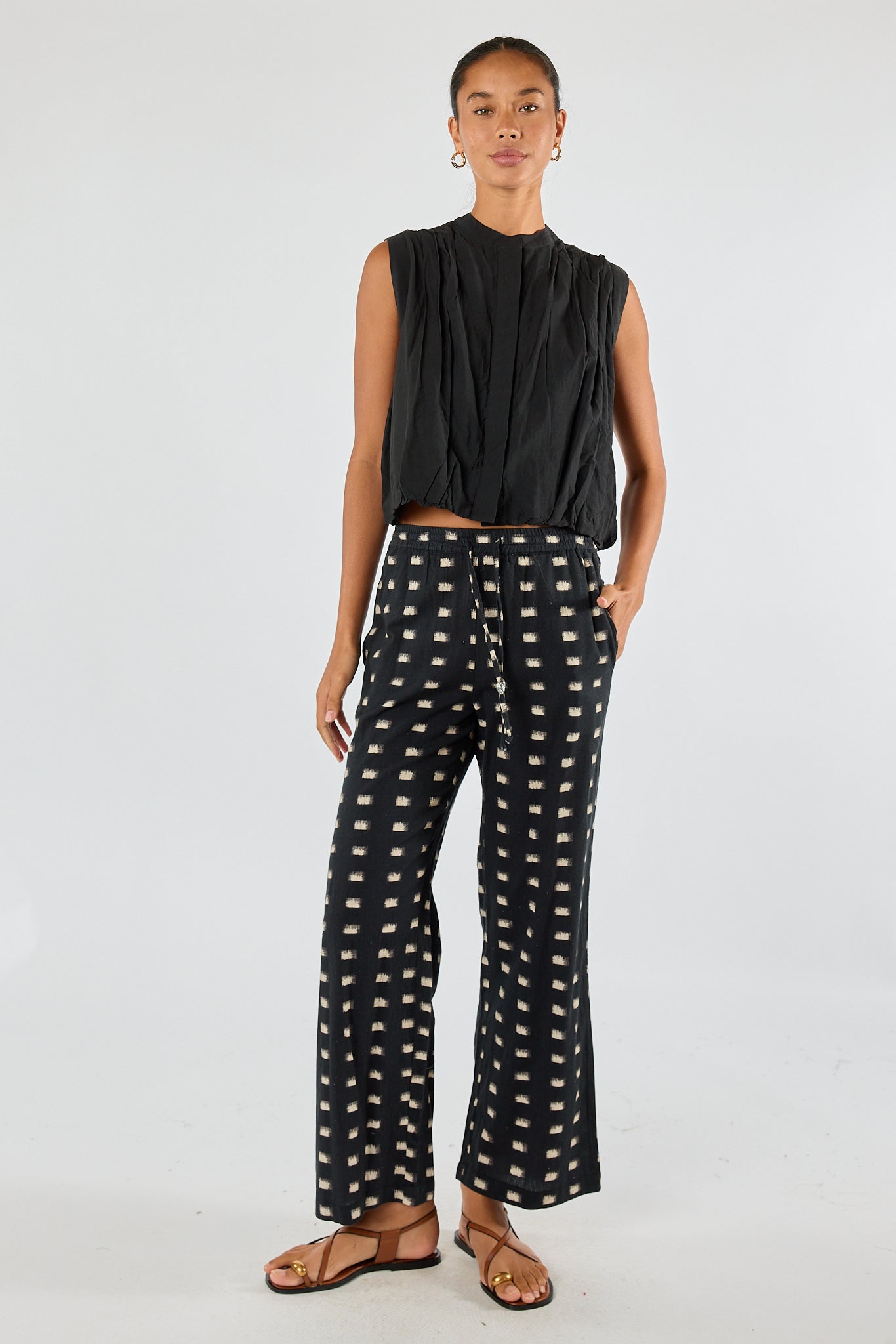 Image of a model wearing Pants. Product name - Itami Rocha Pant Black in Black colour by brand - Itami Division