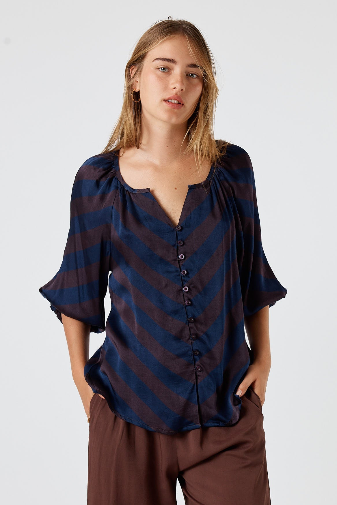Image of a model wearing Tops. Product name - Itami Stripe Button Top Navy in Navy colour by brand - Itami Division