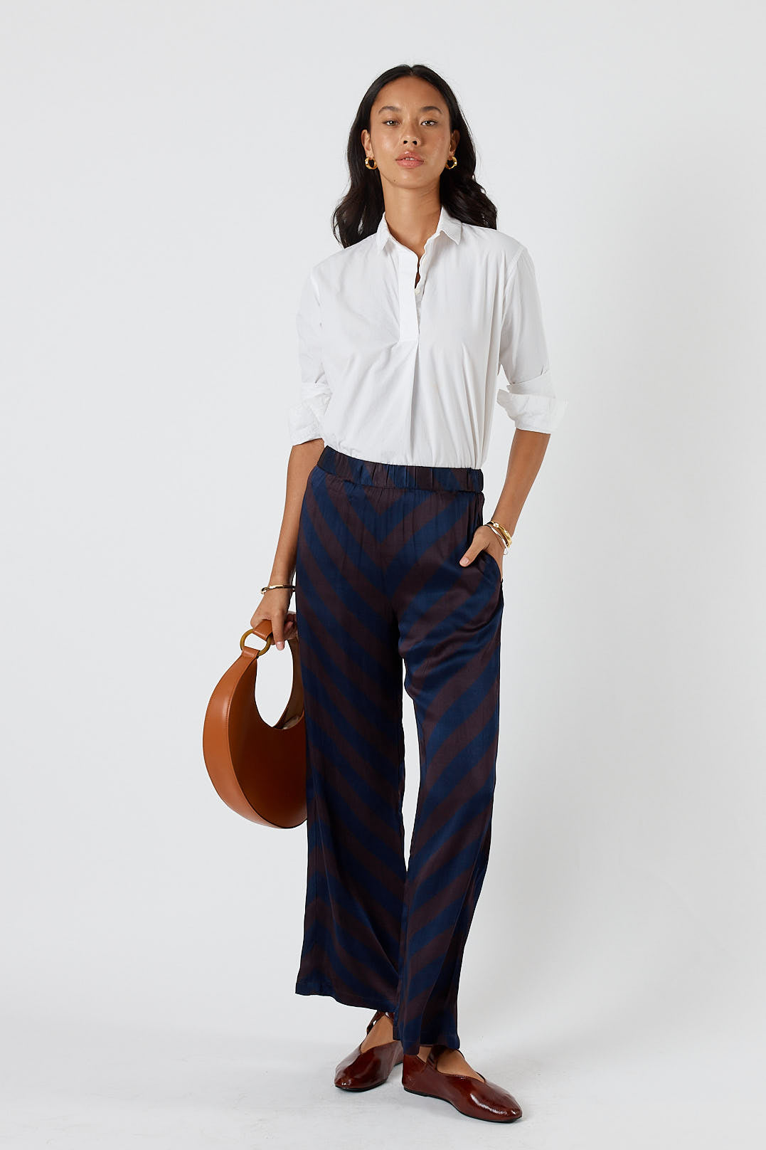 Image of a model wearing Pants. Product name - Itami Stripe Pant Navy in Navy colour by brand - Itami Division