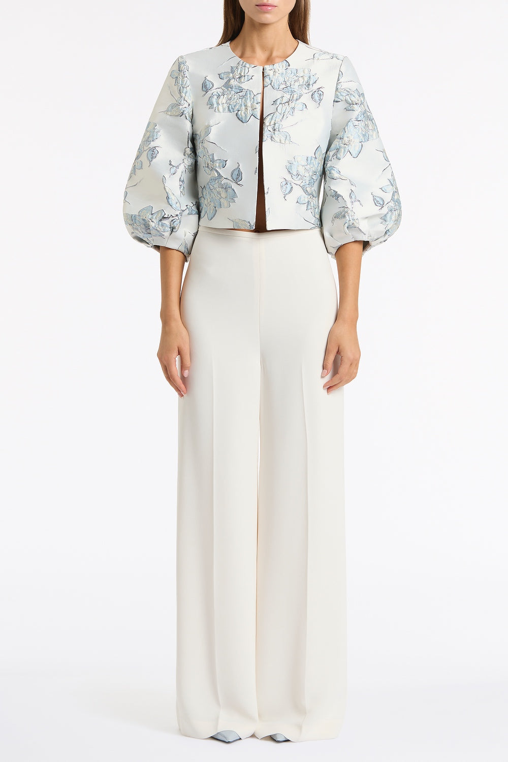 Image of a model wearing Pants. Product name - Ivory Crepe High Waisted Wide Leg Pant in Ivory colour by brand - Carla Zampatti