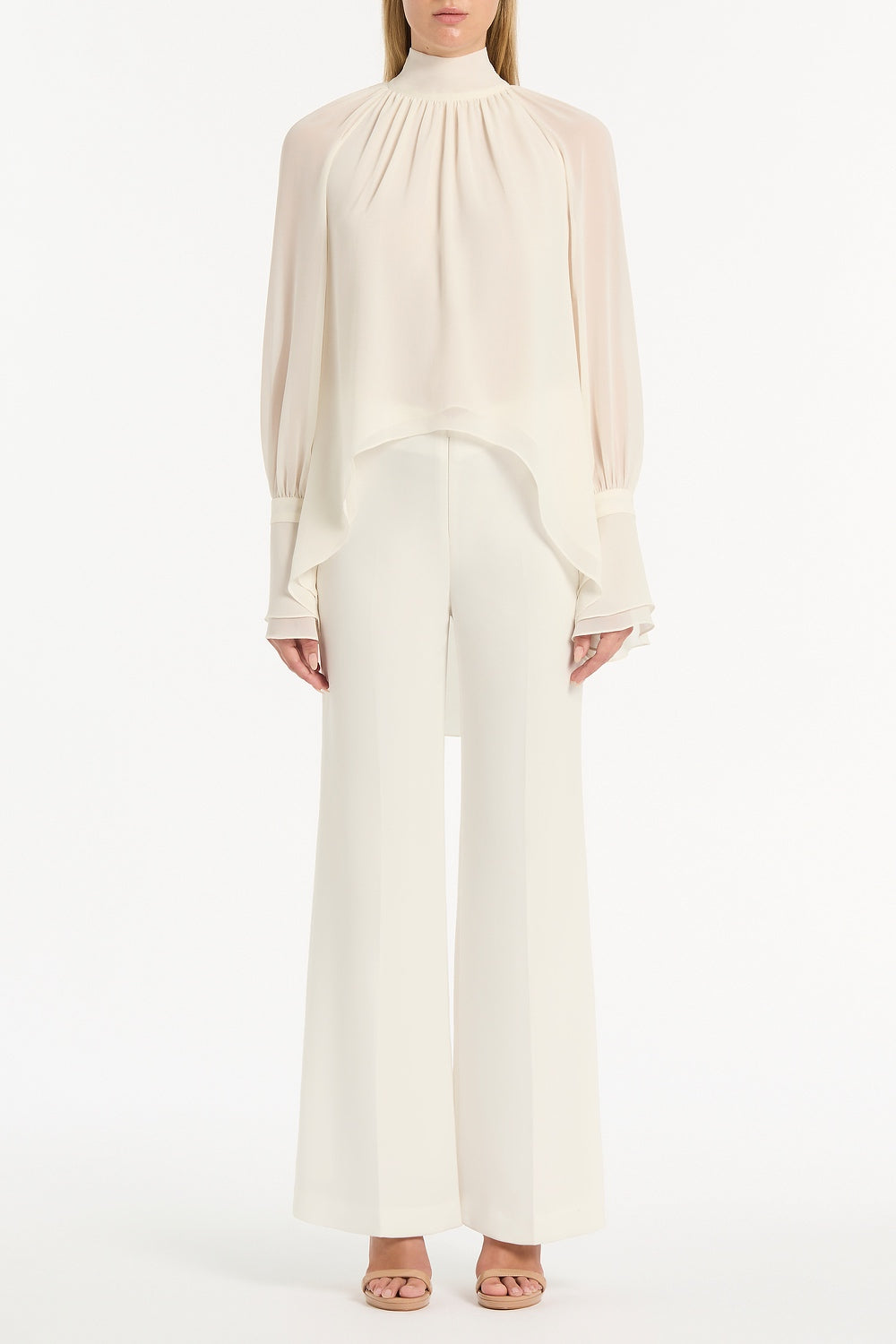 Image of a model wearing Tops. Product name - Ivory Georgette High Low Blouse in White colour by brand - Carla Zampatti