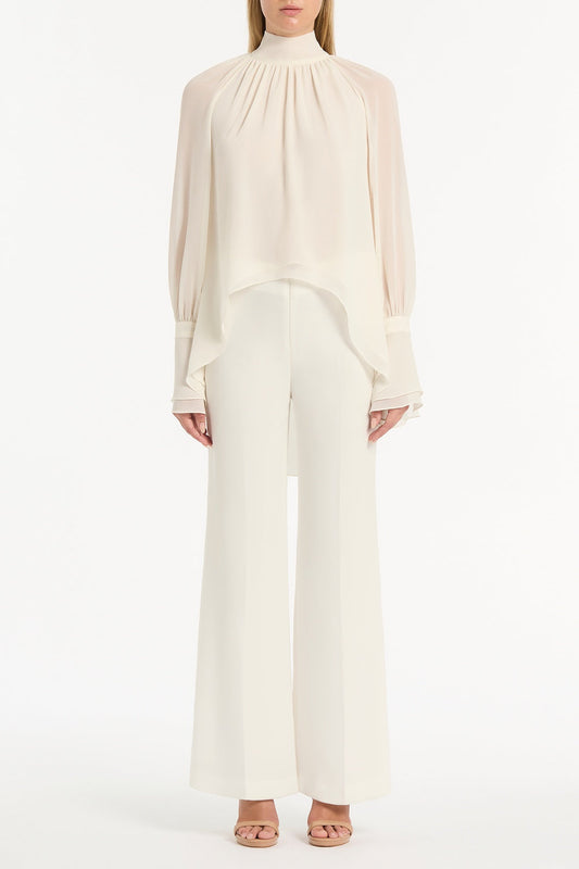 Image of a model wearing Tops. Product name - Ivory Georgette High Low Blouse in White colour by brand - Carla Zampatti