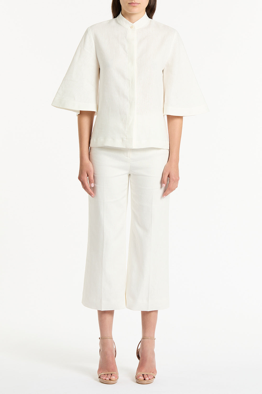 Image of a model wearing Tops. Product name - Ivory Linen Box Sleeve Shirt in White colour by brand - Carla Zampatti