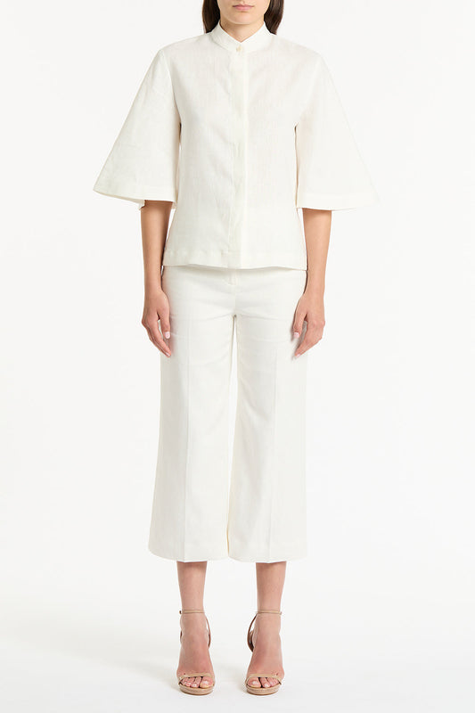 Image of a model wearing Tops. Product name - Ivory Linen Box Sleeve Shirt in White colour by brand - Carla Zampatti