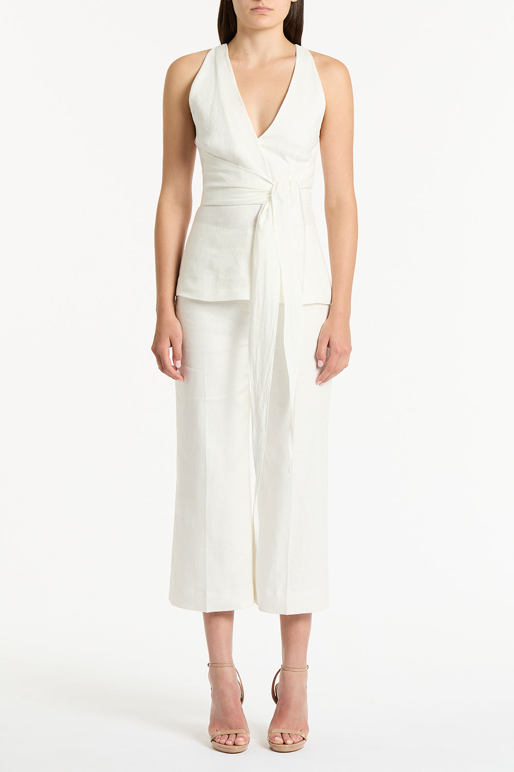 Image of a model wearing Tops. Product name - Ivory Linen V-Neck Wrap Top in White colour by brand - Carla Zampatti
