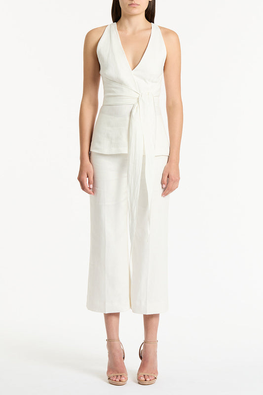 Image of a model wearing Tops. Product name - Ivory Linen V-Neck Wrap Top in White colour by brand - Carla Zampatti