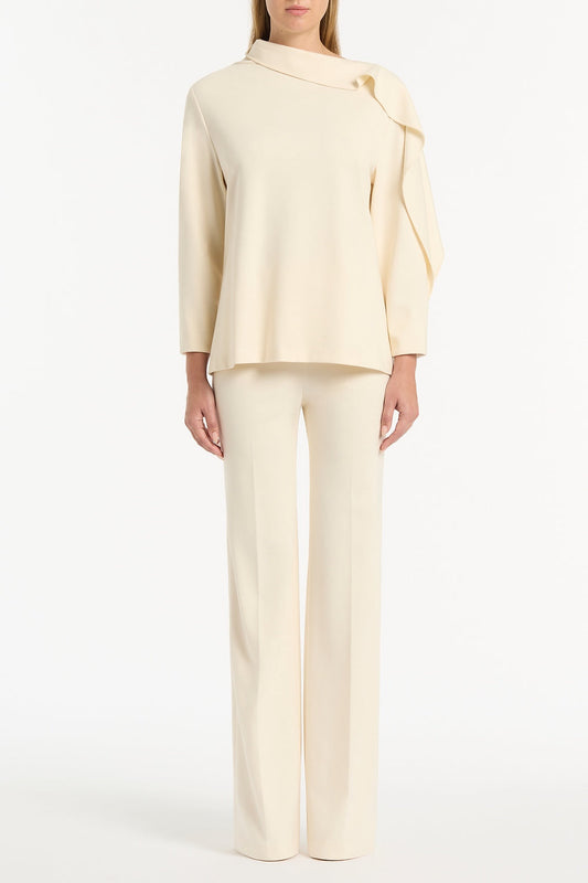 Image of a model wearing Tops. Product name - Ivory Ponte Shoulder Detail Top in Cream colour by brand - Carla Zampatti