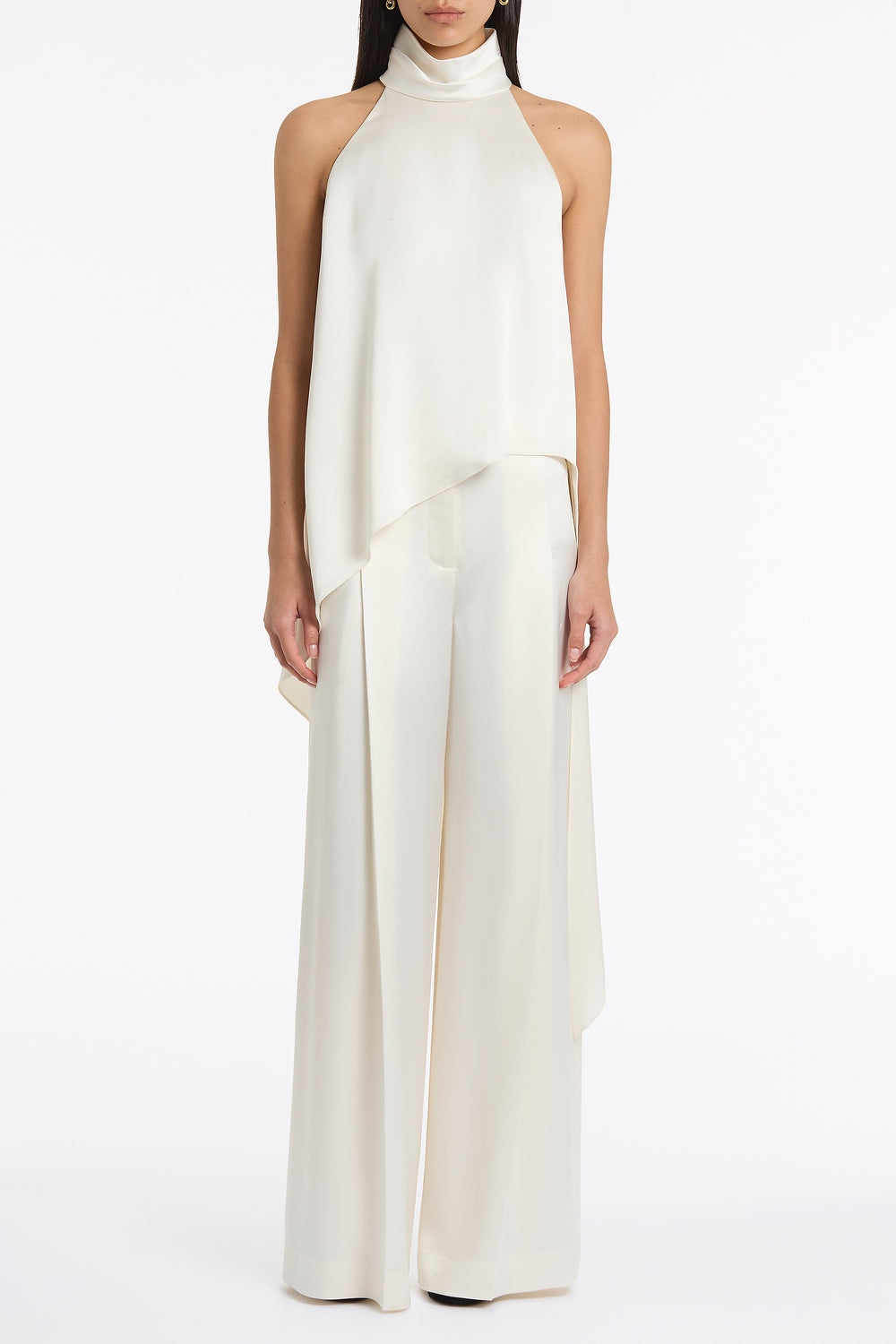 Image of a model wearing Tops. Product name - Ivory Satin Acetate Draped Asymmetric Top in Ivory colour by brand - Carla Zampatti