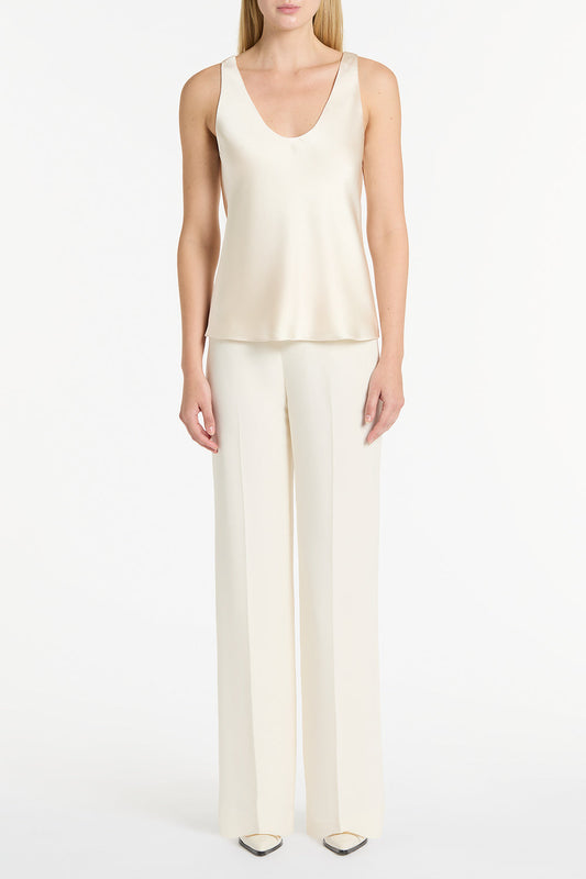 Image of a model wearing Tops. Product name - Ivory Satin Scoop Cami in White colour by brand - Carla Zampatti