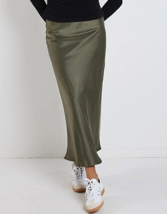 Image of a model wearing Skirts. Productname: Rosette Satin Bias Midi Skirt - in Khaki colour by brand - Ivy & Jack