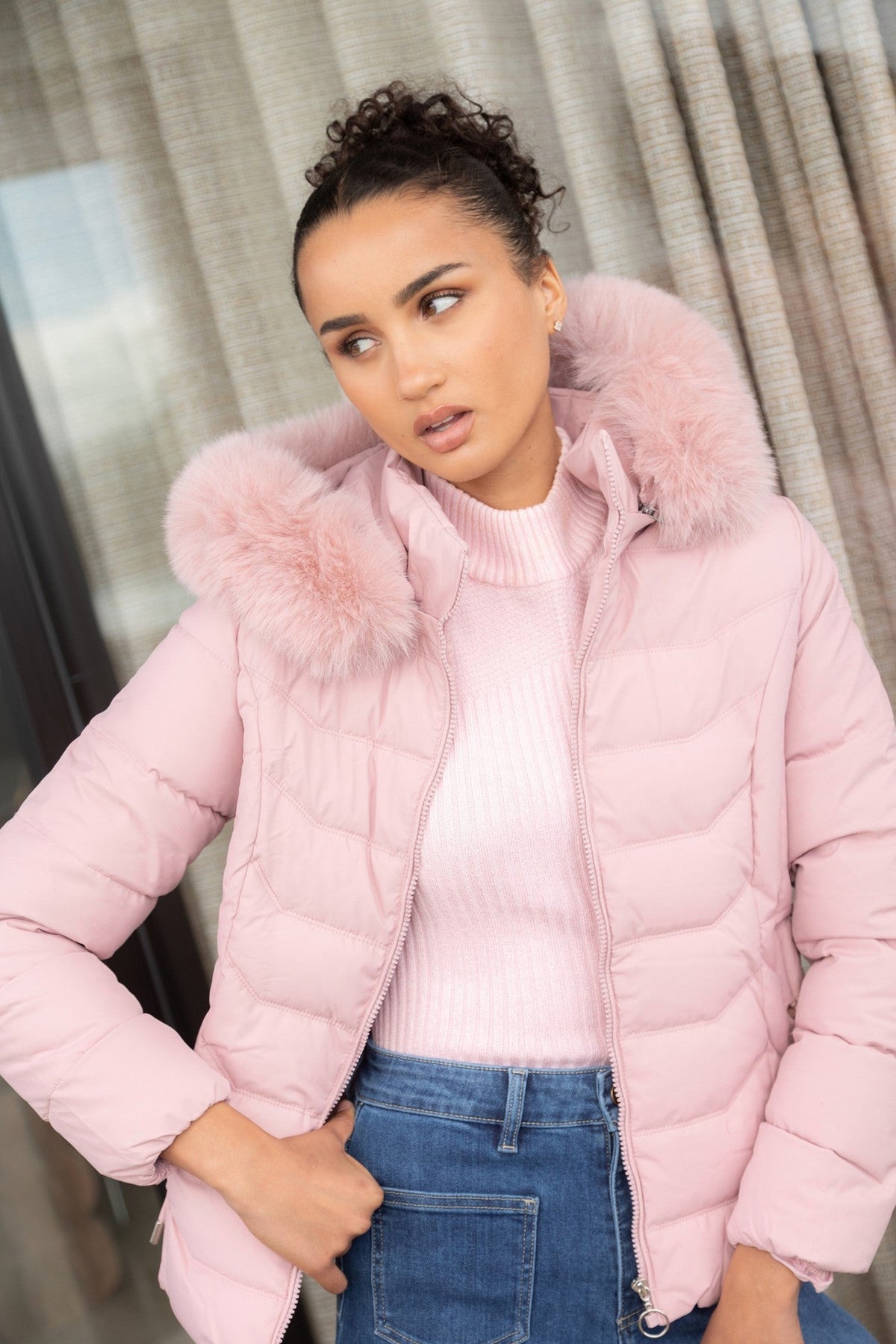 Image of a model wearing Outerwear. Product name - HUA FAUX FUR PUFFER JACKET in Latte colour by brand - Caroline Morgan Australia