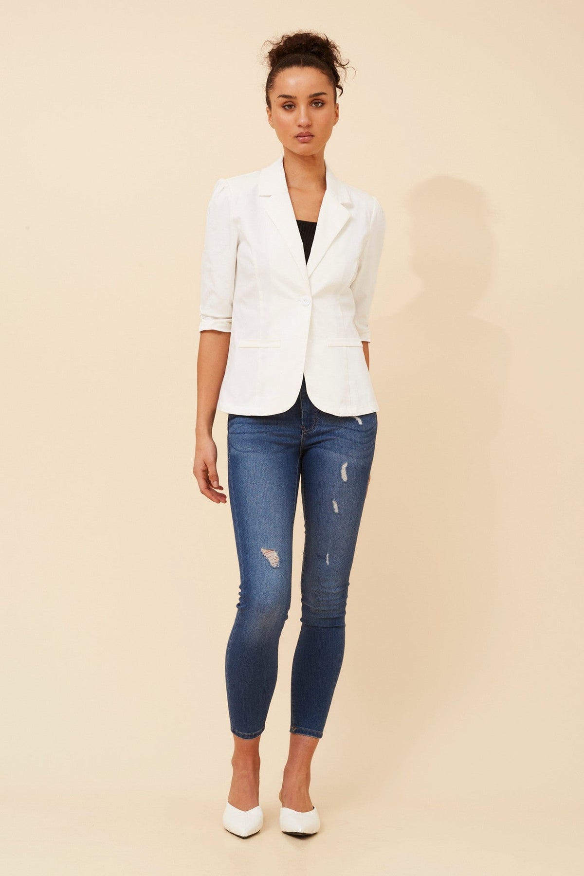 Image of a model wearing Outerwear. Product name - MILOS SOLID BLAZER in White colour by brand - Caroline Morgan Australia