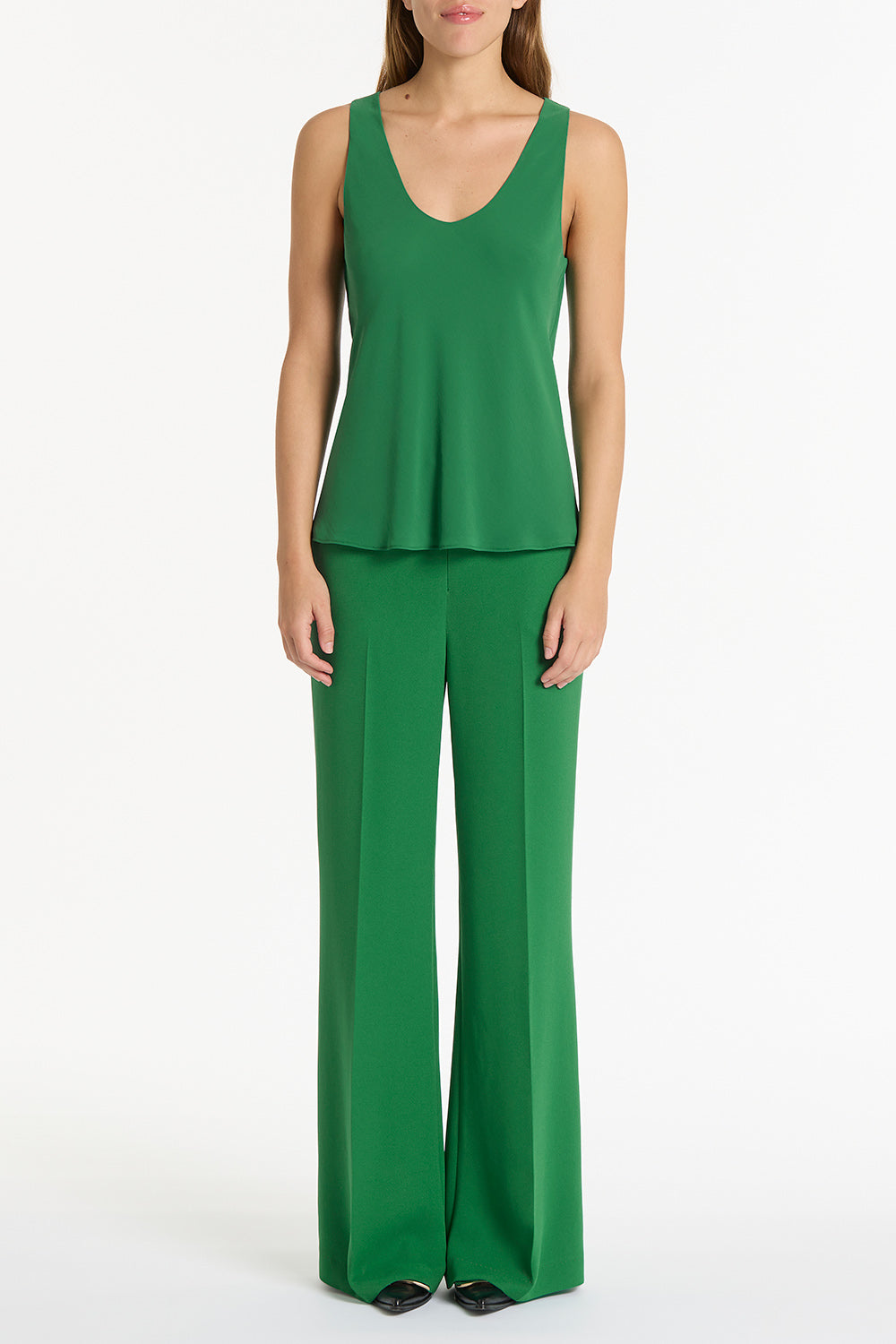 Image of a model wearing Tops. Product name - Jade Georgette Scoop Cami in Green colour by brand - Carla Zampatti