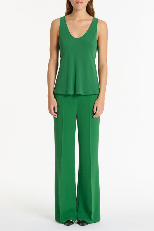 Image of a model wearing Tops. Product name - Jade Georgette Scoop Cami in Green colour by brand - Carla Zampatti