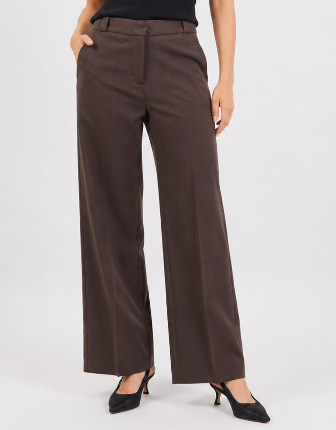 Image of a model wearing Pants. Product name - Jaunty Slant Pocket Wide Leg Pants Dark Chocolate in Dark Chocolate colour by brand - Among The Brave