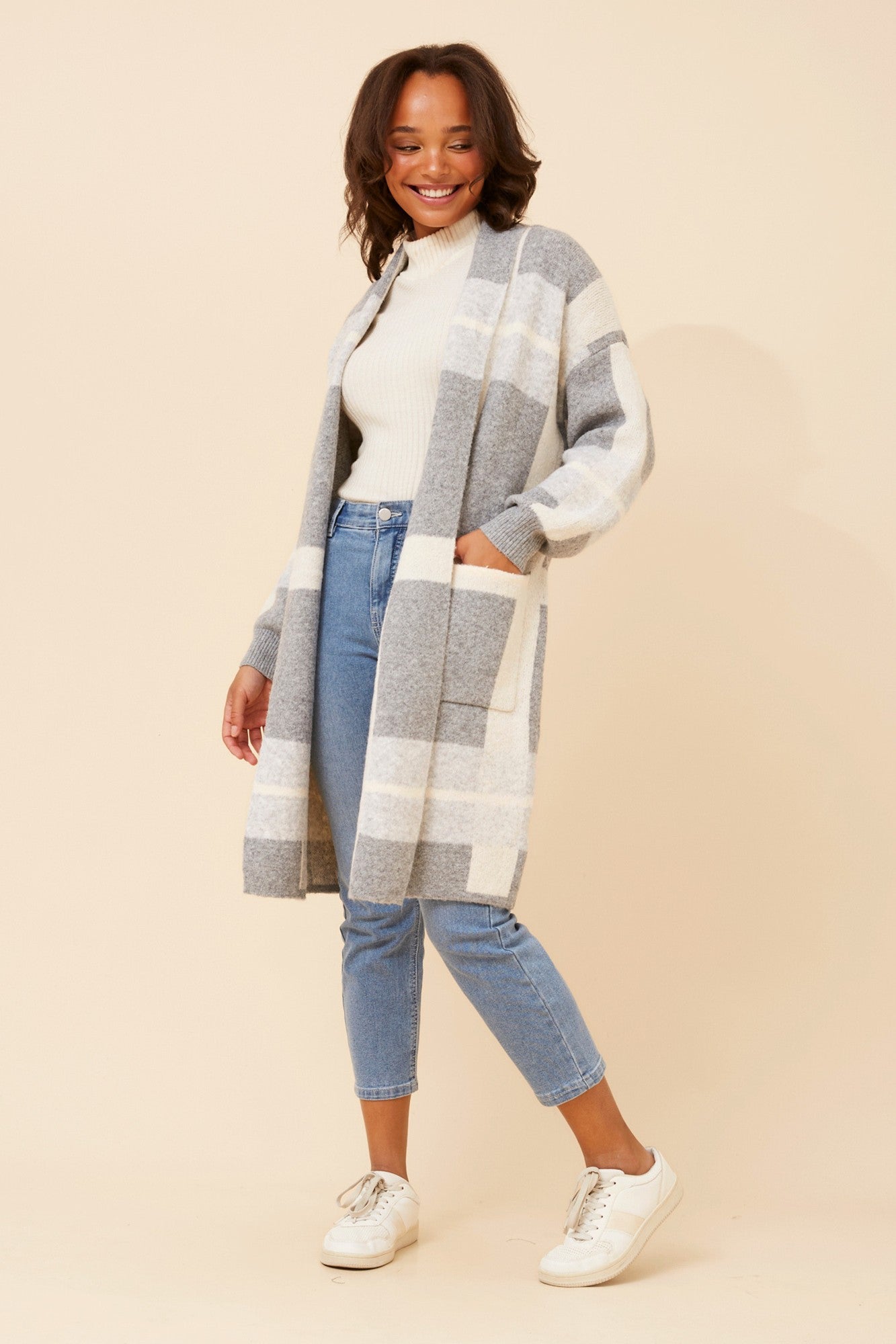 Image of a model wearing Tops. Product name - MAVEN CHECKED PRINT KNIT COATIGAN in Multi Grey colour by brand - Caroline Morgan Australia