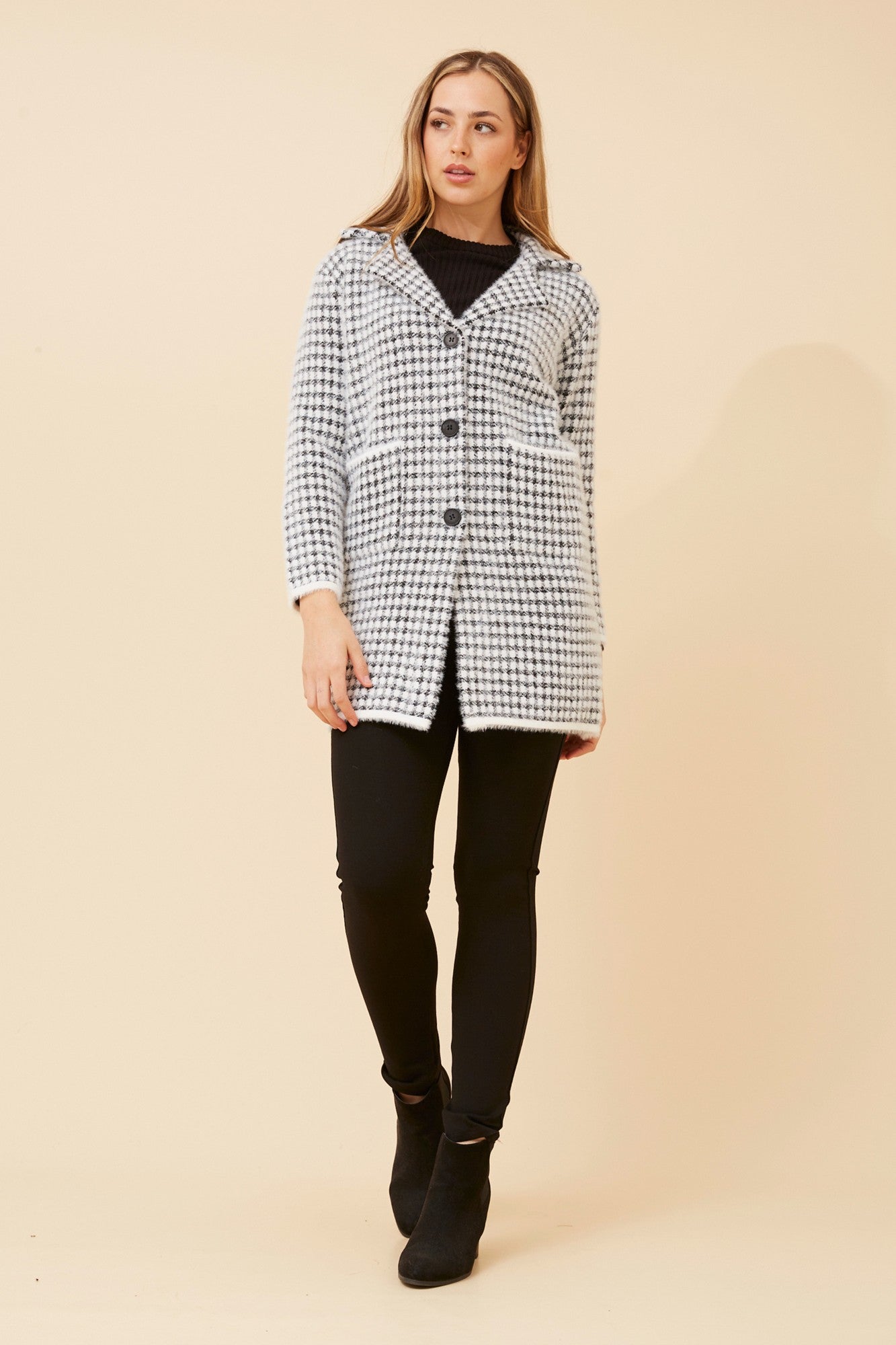 Image of a model wearing Tops. Product name - BRAD HOUNDSTOOTH PRINT KNIT COATIGAN in White colour by brand - Caroline Morgan Australia