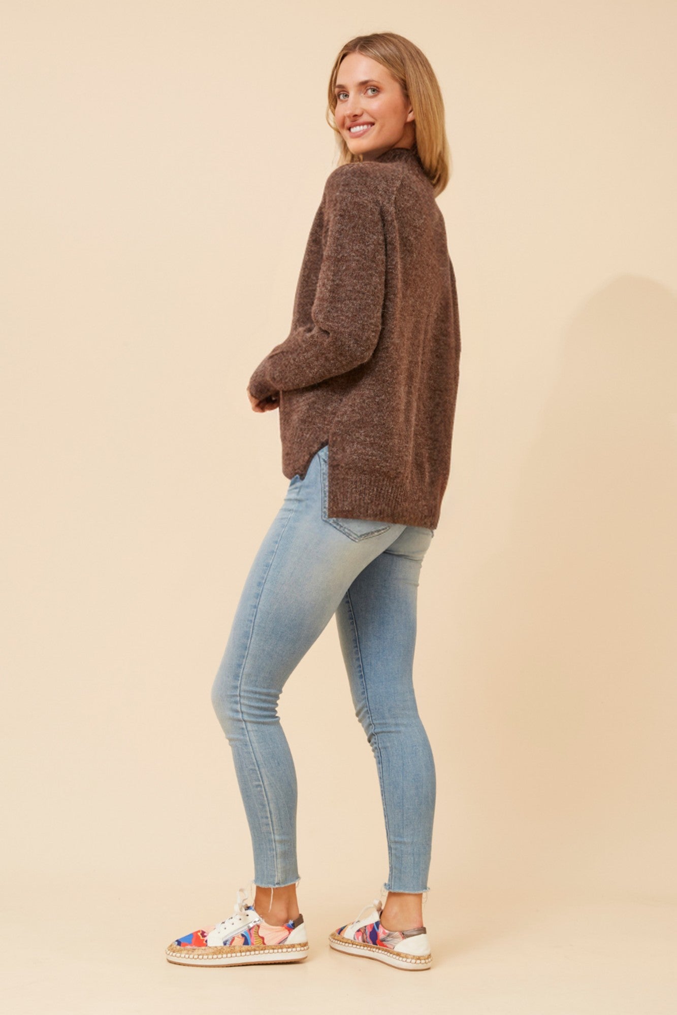 Image of a model wearing Outerwear. Product name - GRETCHEN SOLID KNIT JUMPER in Jade colour by brand - Caroline Morgan Australia