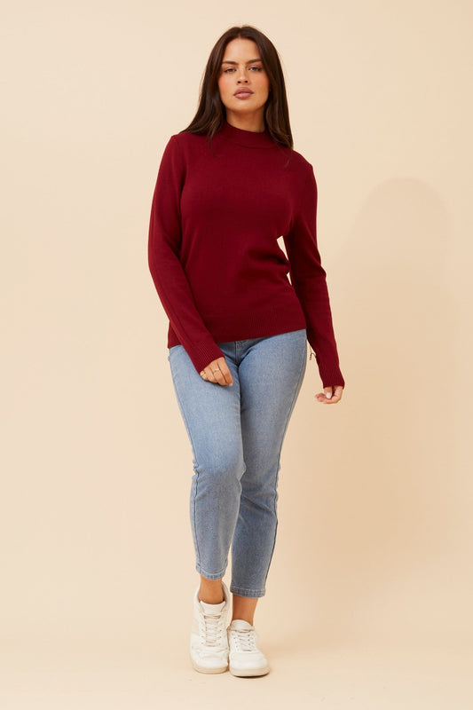Image of a model wearing Tops. Product name - PETUNIA TURTLE NECK KNIT PULLOVER in Burgundy colour by brand - Caroline Morgan Australia